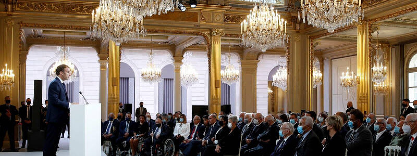 French president Emmanuel Macron delivers a speech during a ceremony in memory of the Harkis, Algerians who helped the French Army in the Algerian War of Independence, at the Elysee Palace in Paris, on September 20, 2021. (Photo by GONZALO FUENTES / POOL / AFP)